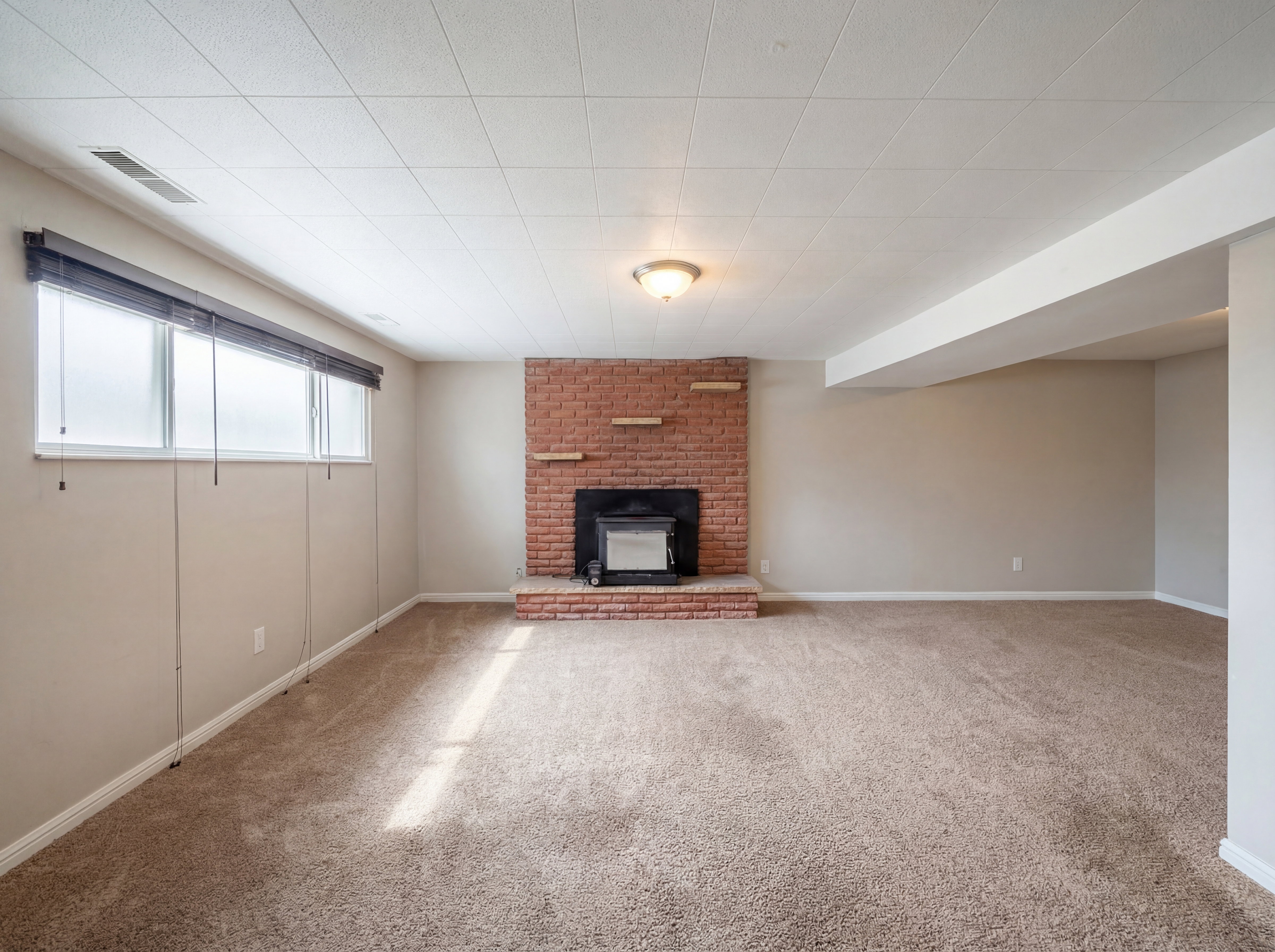 Unfurnished living room with carpet flooring and baseboards