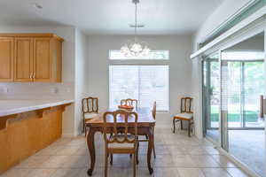 Dining room featuring a chandelier and light tile patterned floors