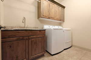 Laundry room featuring cabinet space and washer and clothes dryer