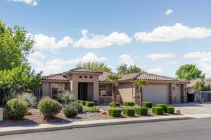 Mediterranean / spanish house with a garage, stucco siding, concrete driveway, and a tile roof
