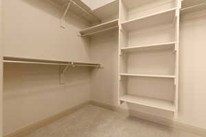 Walk in closet with light carpet