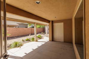 Fenced backyard with a patio