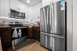 Kitchen featuring stainless steel appliances, granite countertops, and an island for extra eating space.