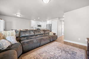 Spacious Family Room with LVP flooring, two-tone paint, and recessed lighting.