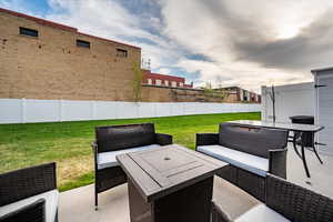 Fenced backyard with a patio and outdoor seating