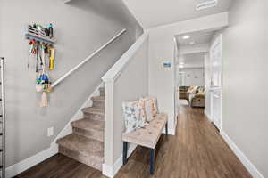 Welcoming entry with carpeted staircase, two-tone paint, and LVP flooring.