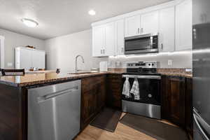 Kitchen featuring stainless steel appliances, granite countertops, and an island for extra eating space.