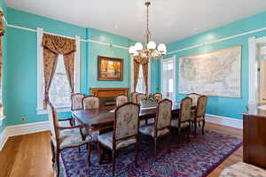 Dining area with suspended lighting and wood finished floors
