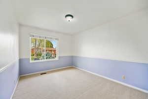 Empty room with light carpet and baseboards