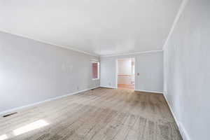Spare room with light carpet and ornamental molding