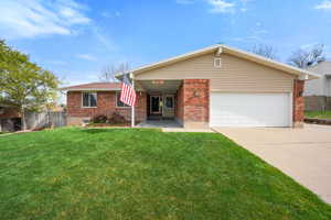 Ranch-style house featuring concrete driveway, a garage, and brick siding
