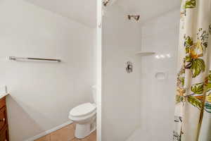 Full bathroom with vanity, a stall shower, and light tile patterned floors