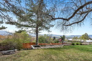 Fenced backyard featuring a patio area and a mountain view