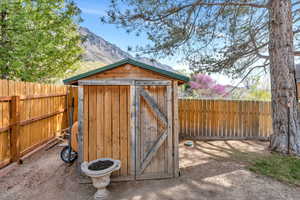 View of shed featuring a fenced backyard and a mountain view