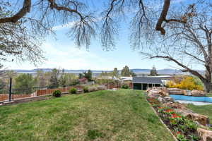 Fenced yard featuring a mountain view