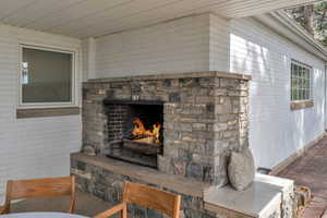 Detailed view of a stone fireplace and brick wall