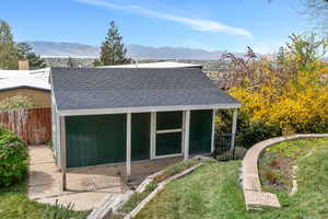 View of outbuilding featuring a mountain view and a sunroom