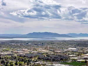 View of mountain background with a nearby body of water and nearby suburban area