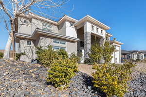 View of front of property featuring stucco siding and an attached garage