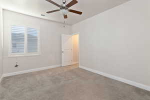 Empty room with light colored carpet and ceiling fan