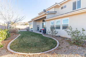 Back of house with stucco siding and a patio area