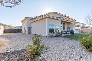 Back of house with a fenced backyard, stucco siding, and a patio