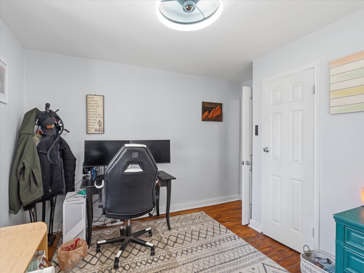 Office featuring dark wood-style flooring and baseboards