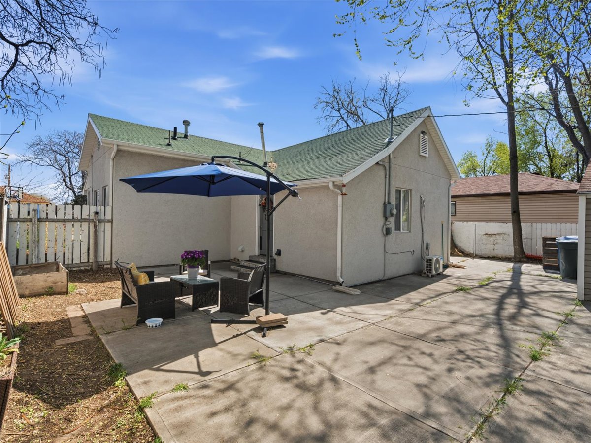 Back of property with stucco siding, an outdoor living space, and a patio