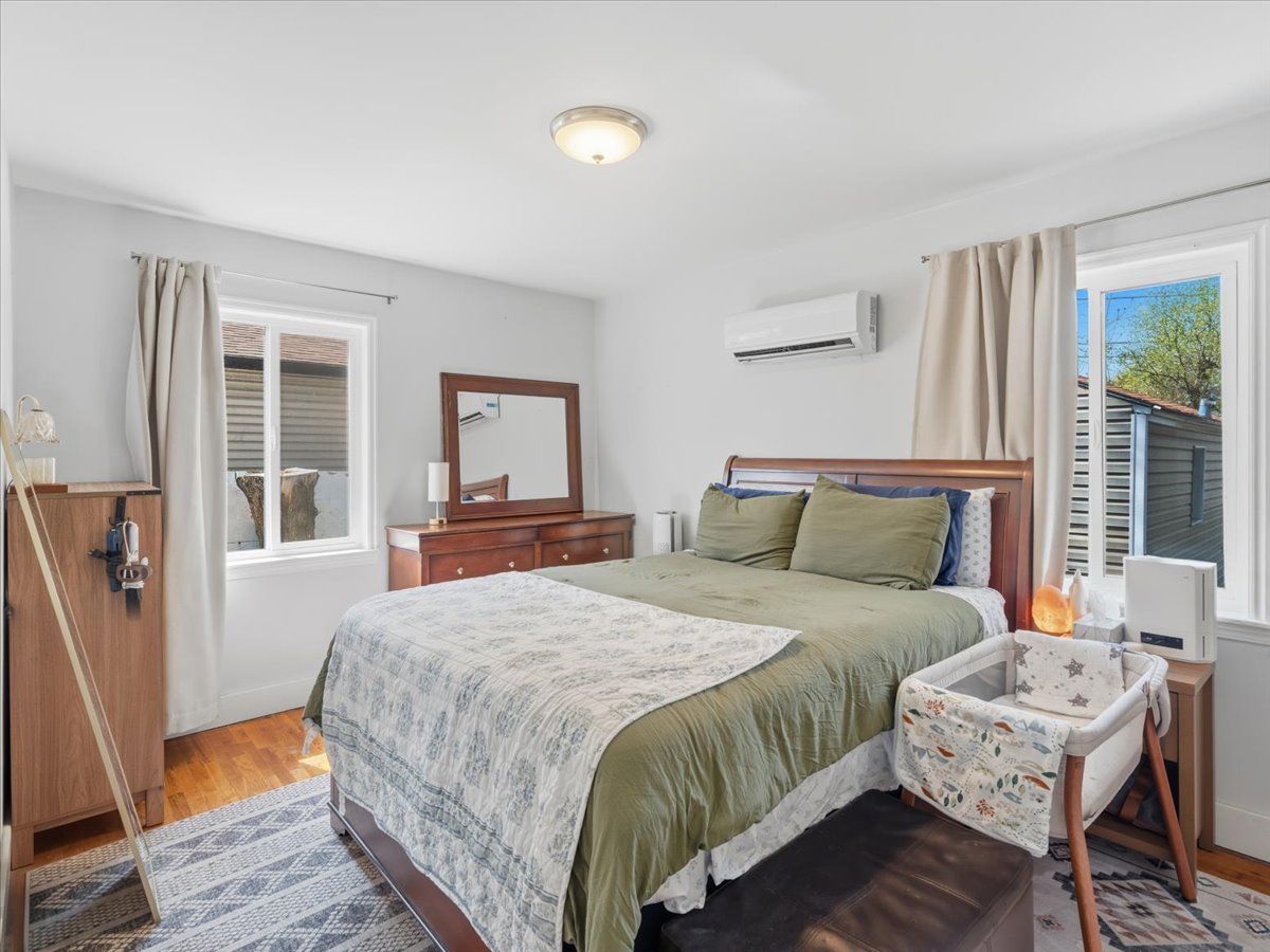 Bedroom featuring wood finished floors and a mini split for heating / cooling