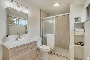 Full bathroom featuring vanity and a stall shower