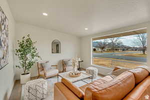 Living room with wood finished floors and recessed lighting