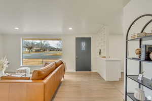 Entrance foyer featuring light wood-style flooring, a textured ceiling, and recessed lighting