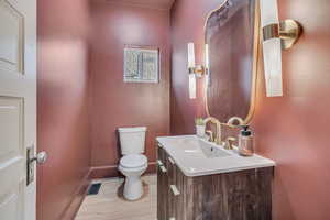 Half bath featuring vanity and light wood finished floors