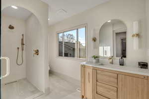 Full bath with vanity, a stall shower, light marble finish floors, and recessed lighting