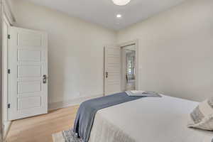 Bedroom with light wood-style floors and recessed lighting