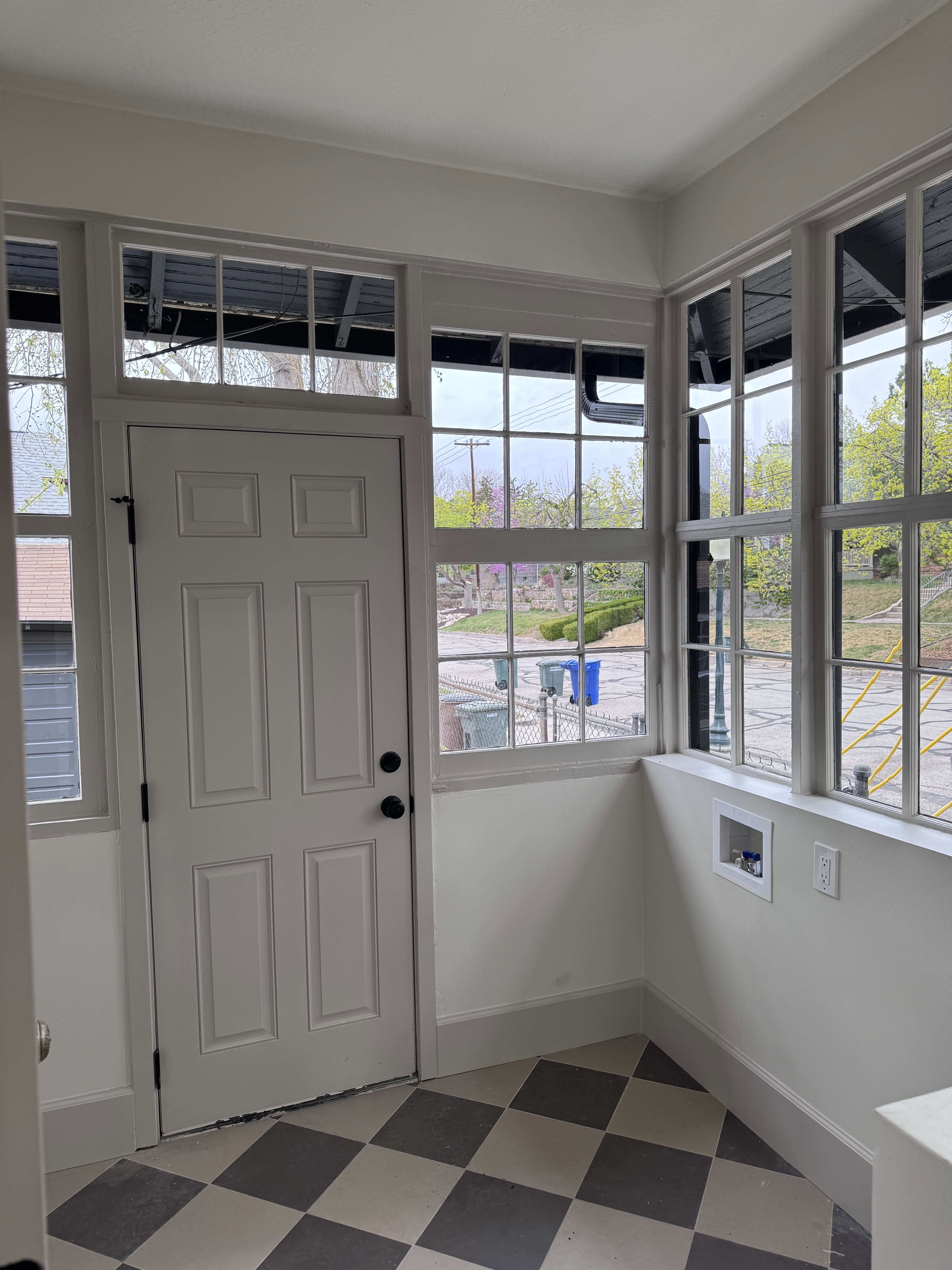 Foyer entrance with light floors and baseboards