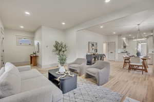 Living area with light wood-style floors and recessed lighting