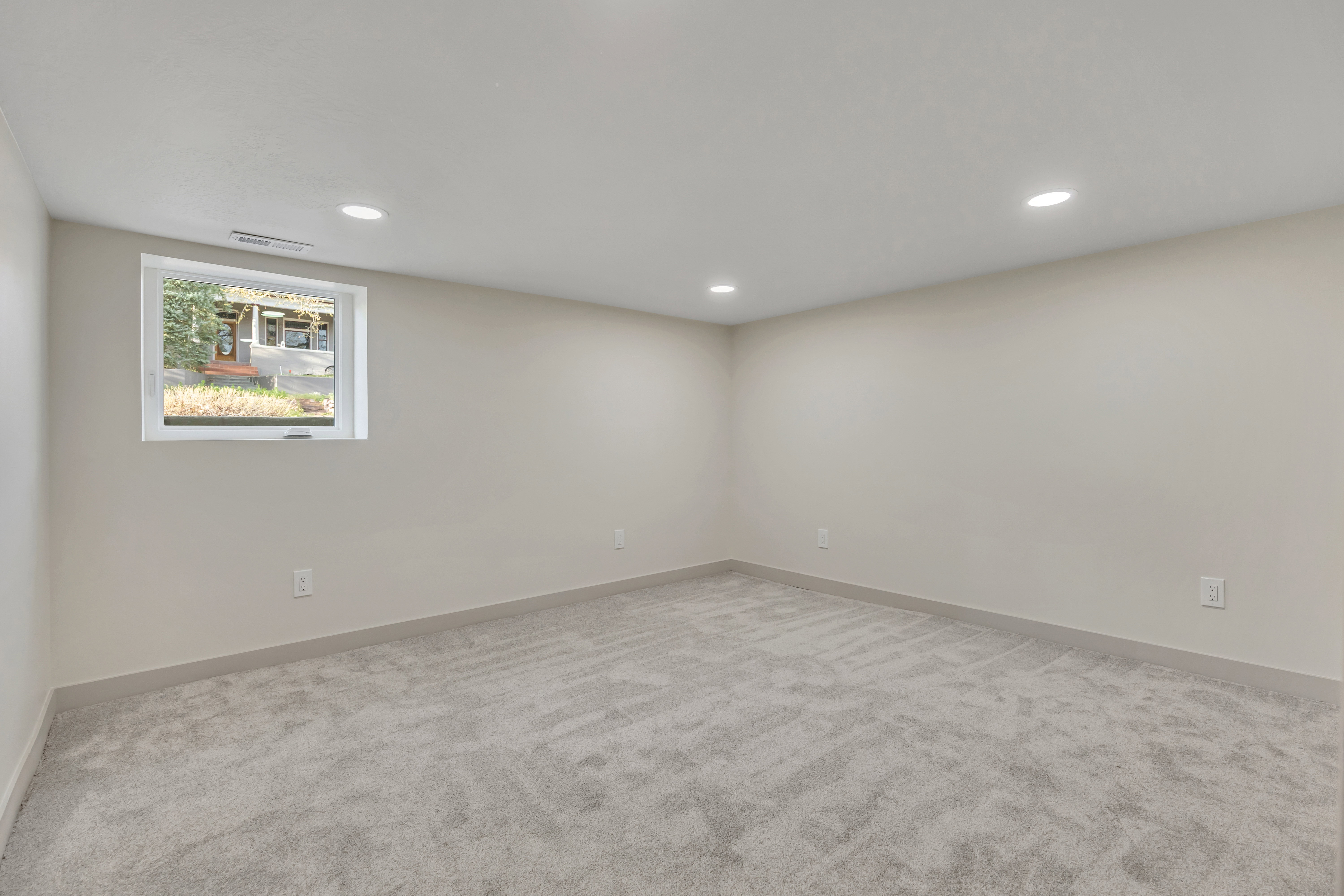 Empty room featuring light carpet and recessed lighting