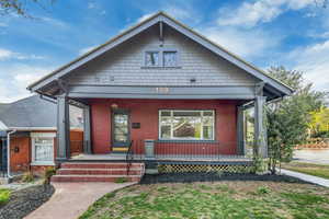 View of front facade featuring a porch and brick siding
