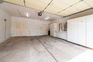 2 Car Garage with built-in cabinetry and extra storage space & water hookup
