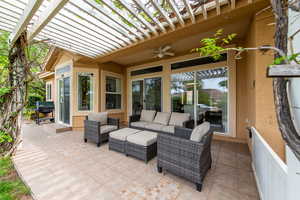 Covered patio with seating area and access to living and dining spaces