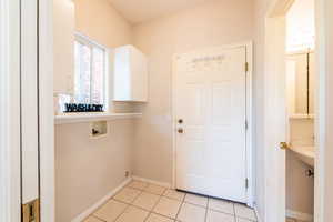 Laundry room with access to garage and convenient half bath, just off the kitchen