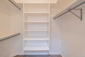 Well-designed walk-in closet with shelving and great storage, primary bedroom