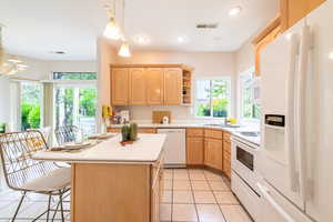 Spacious kitchen with island, ample cabinetry, and natural light