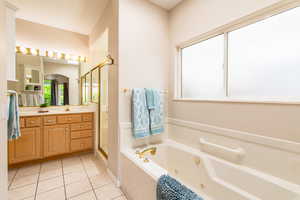 Inviting primary bathroom with jetted tub and separate shower