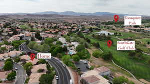 Aerial view of residential area featuring a local golf course and a water and mountain view