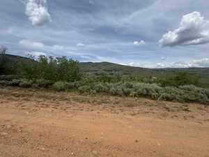 View of mountain backdrop featuring rural landscape