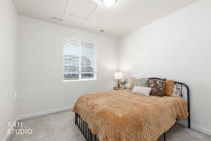 Bedroom with light carpet and baseboards