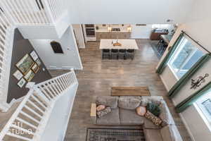 Living area featuring a high ceiling and dark wood-style flooring