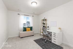 Office space featuring light carpet and baseboards